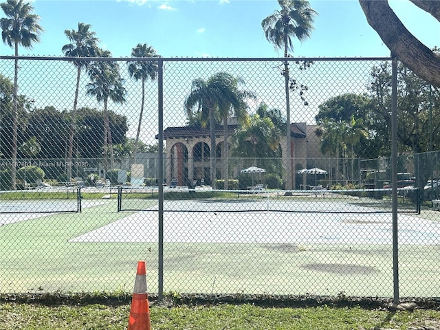 view of tennis court featuring fence