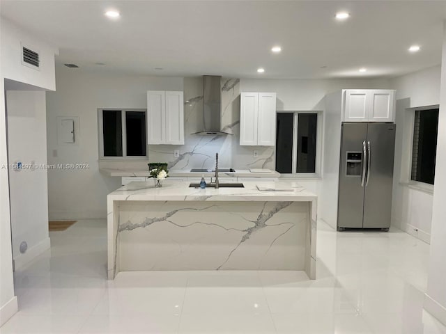 1201 Marseille Dr Unit 17, Miami Beach, FL 33141 - kitchen with stainless steel fridge with ice dispenser, wall chimney range hood, recessed lighting, white cabinets, and light stone countertops
