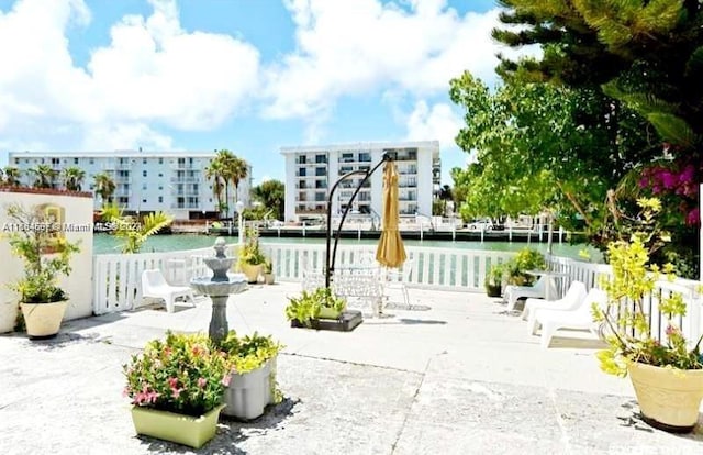 view of property's community featuring a water view and a patio area