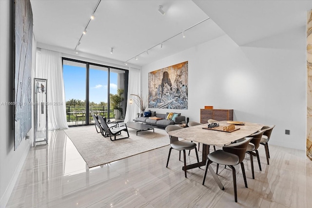 dining room featuring rail lighting and light tile patterned floors