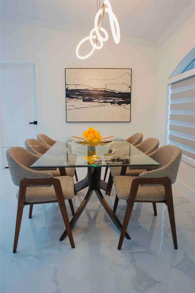 dining room with an inviting chandelier and ornamental molding