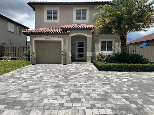 mediterranean / spanish-style home with a garage