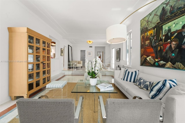 living room featuring light wood-type flooring and crown molding