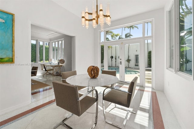 dining space with french doors, a healthy amount of sunlight, and a chandelier