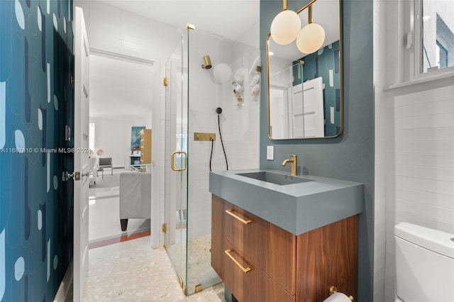 bathroom with walk in shower, vanity, and toilet