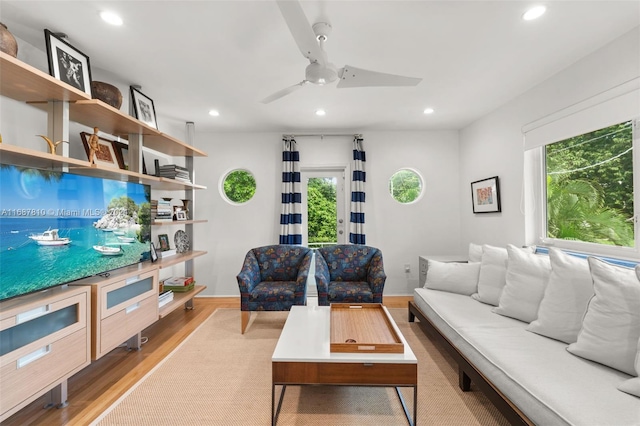 living room with ceiling fan and light hardwood / wood-style flooring