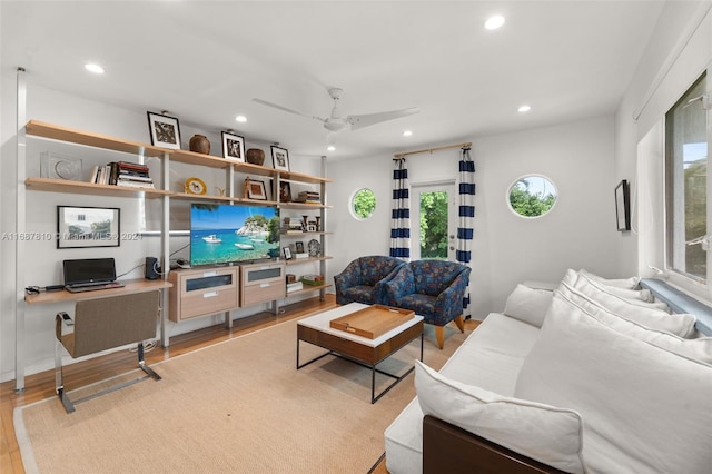 living room featuring ceiling fan and light hardwood / wood-style floors