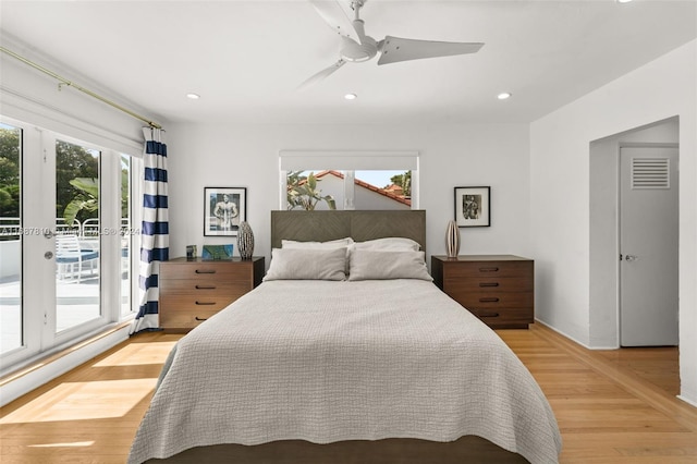 bedroom with light hardwood / wood-style floors, ceiling fan, and access to exterior