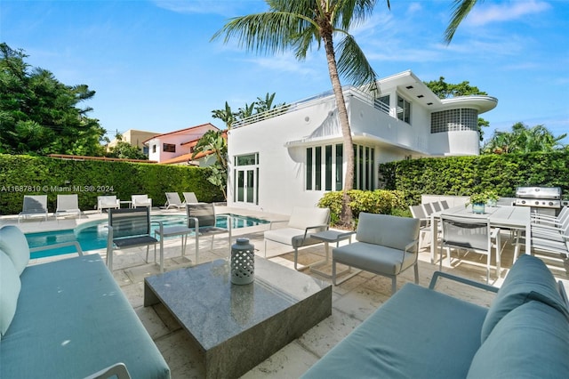 view of swimming pool featuring area for grilling, a patio, and an outdoor living space