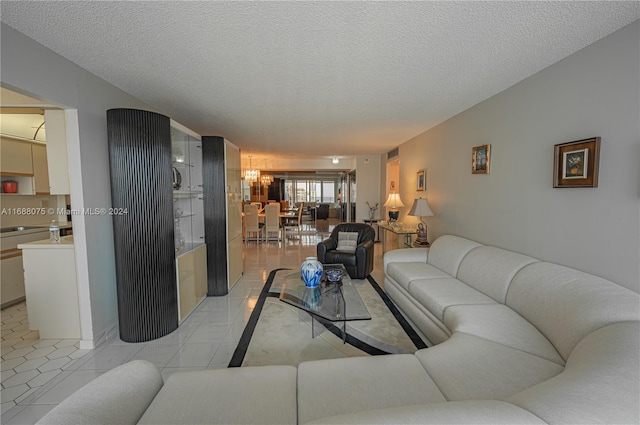 tiled living room featuring a textured ceiling