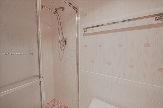 bathroom featuring a shower with shower door