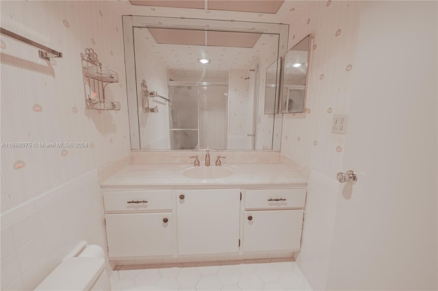 bathroom with walk in shower, vanity, and toilet