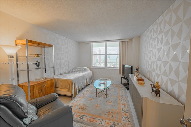 bedroom featuring tile walls and a textured ceiling