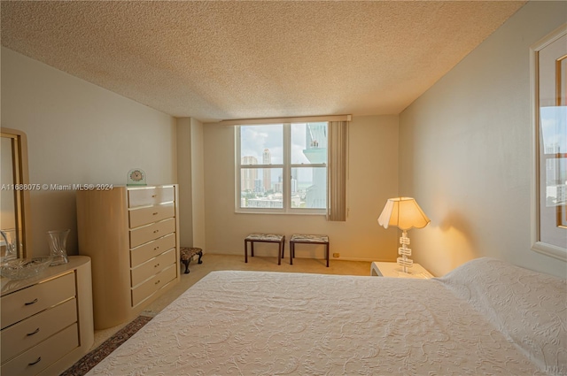 carpeted bedroom featuring a textured ceiling