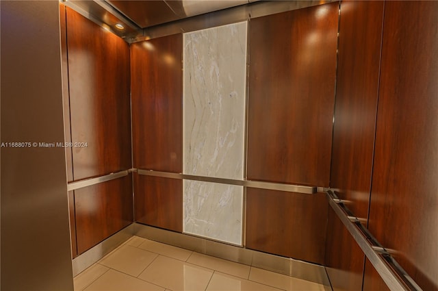 details with elevator and tile patterned flooring