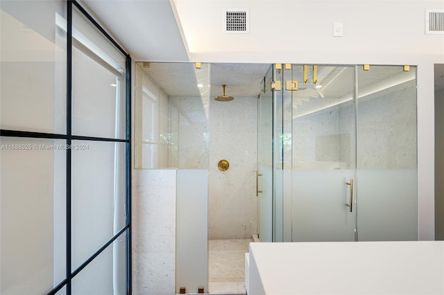 bathroom with a shower with shower door