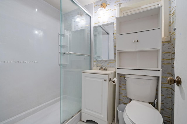 bathroom with walk in shower, vanity, and toilet