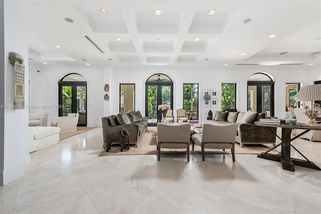 living room featuring beamed ceiling, french doors, and a healthy amount of sunlight