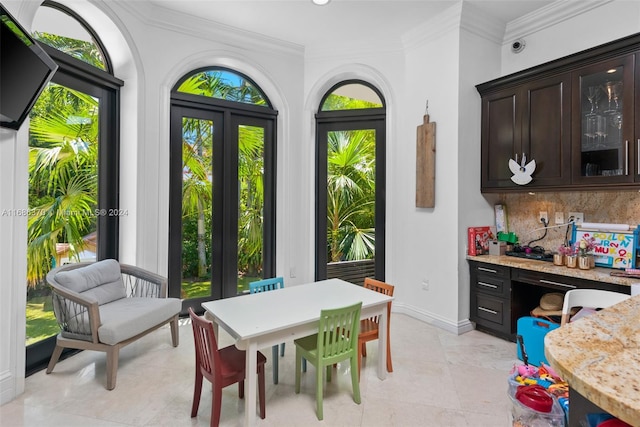 interior space with light tile patterned floors and ornamental molding