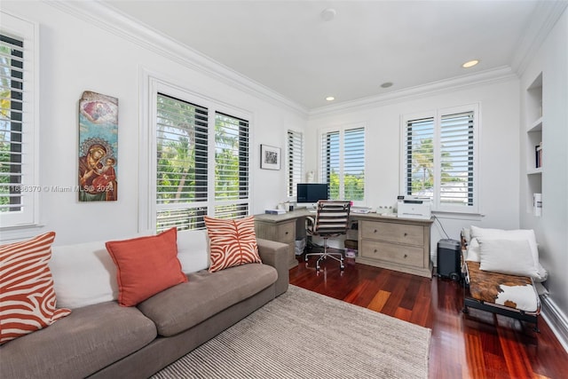 office area featuring ornamental molding, built in features, dark wood-type flooring, and a healthy amount of sunlight