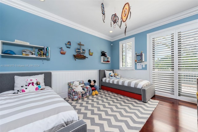 bedroom with hardwood / wood-style floors and ornamental molding