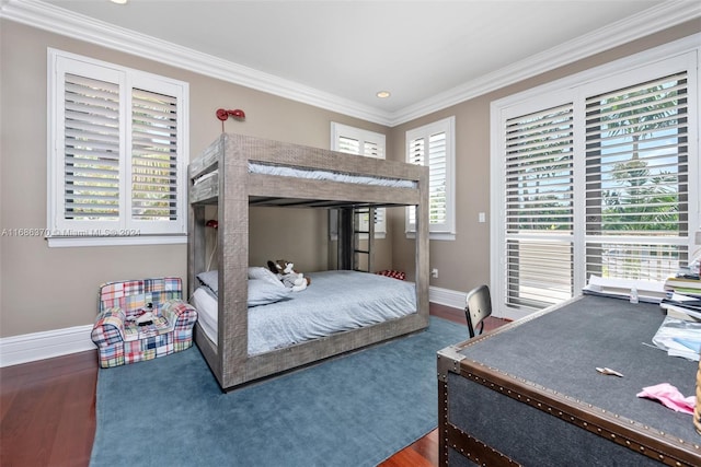 bedroom featuring dark hardwood / wood-style floors, multiple windows, and ornamental molding