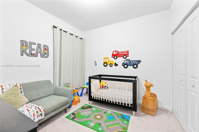 bedroom featuring carpet flooring and a nursery area