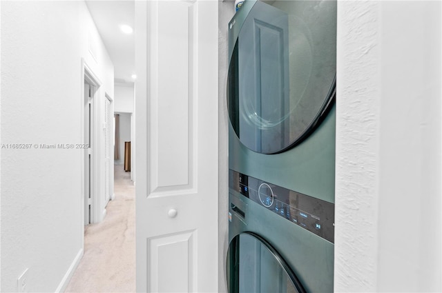 laundry area featuring stacked washer and dryer