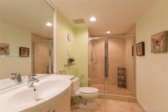 bathroom with sink, tile patterned floors, toilet, and walk in shower