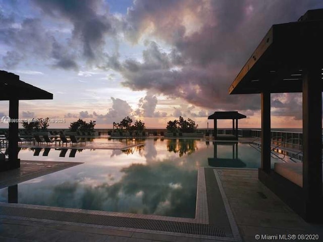 pool at dusk with a water view