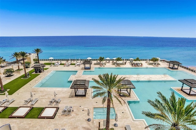 view of pool with a water view