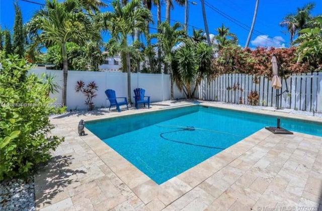 view of swimming pool with a patio area