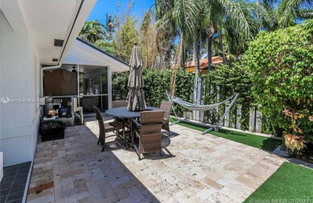 view of patio featuring a sunroom