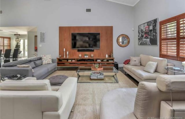 living room with plenty of natural light and high vaulted ceiling