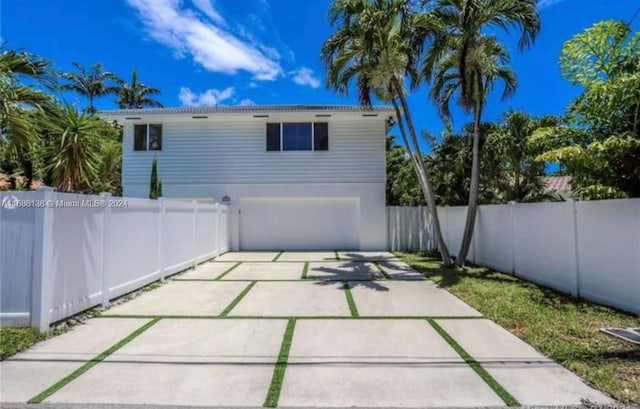 back of house with a garage