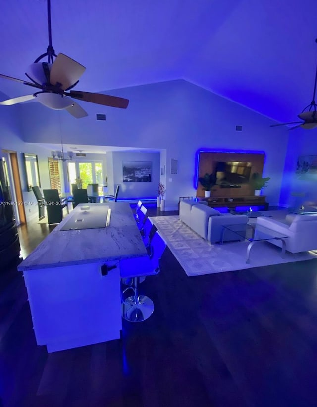 living room with high vaulted ceiling, hardwood / wood-style flooring, and ceiling fan