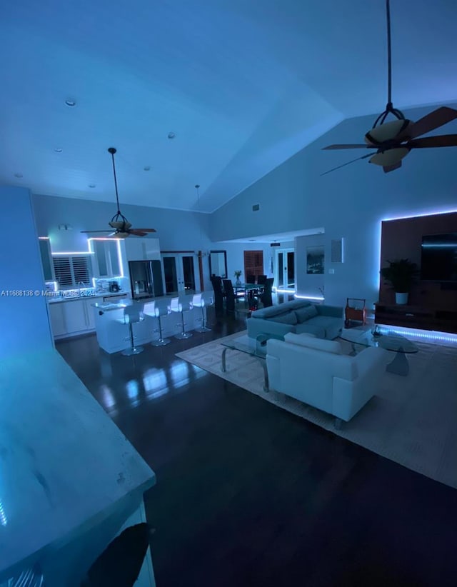 living room with high vaulted ceiling and hardwood / wood-style flooring