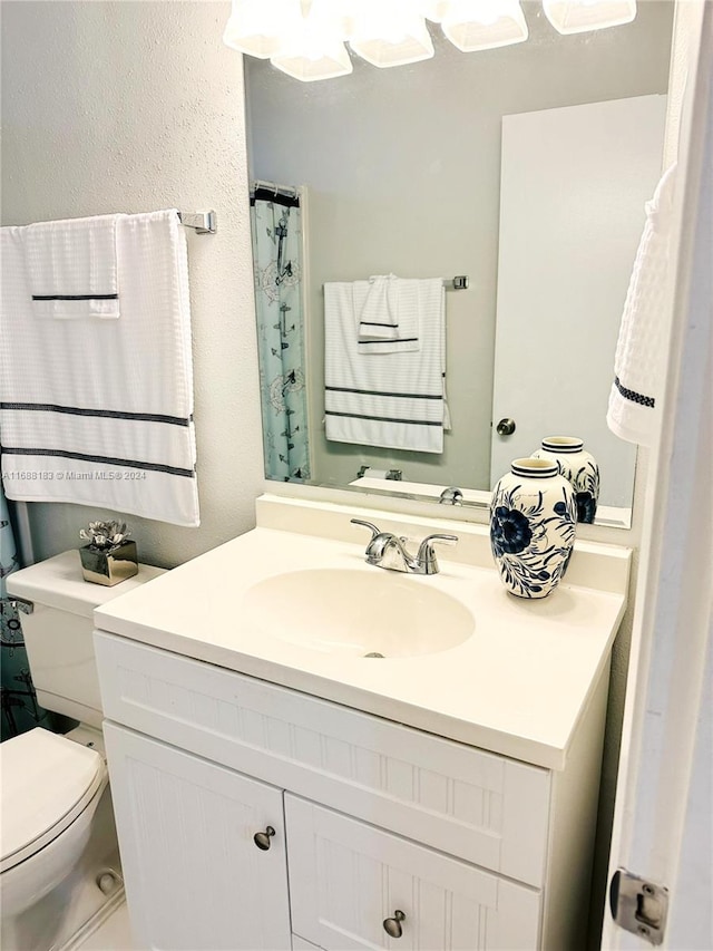 bathroom featuring toilet and vanity