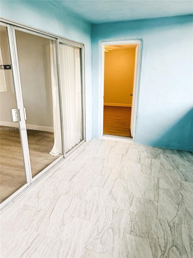 unfurnished bedroom with a closet and light wood-type flooring