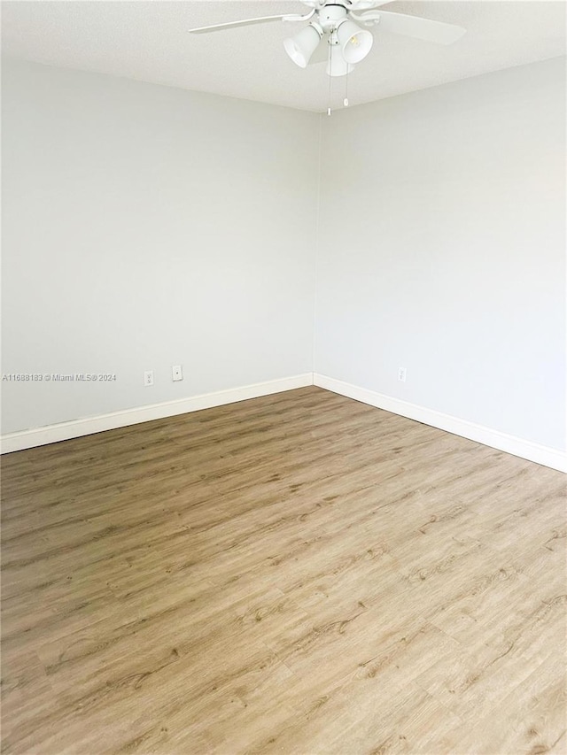 unfurnished room featuring light wood-type flooring and ceiling fan