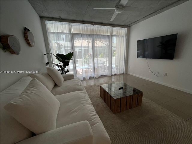 living room with ceiling fan and tile patterned flooring