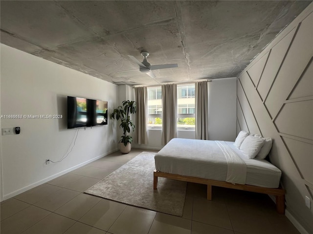 bedroom with ceiling fan and light tile patterned floors