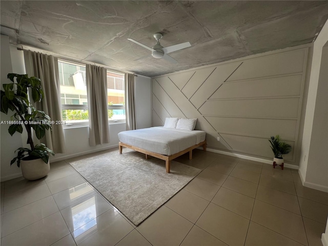 unfurnished bedroom with light tile patterned flooring and ceiling fan