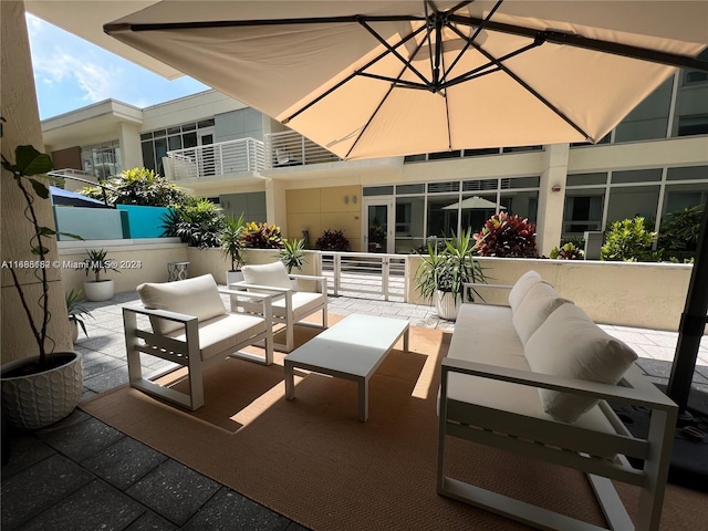 view of patio with a balcony and an outdoor living space