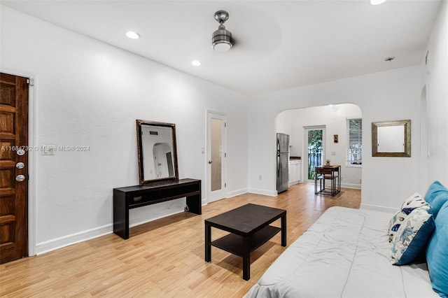 living room featuring ceiling fan and light hardwood / wood-style floors