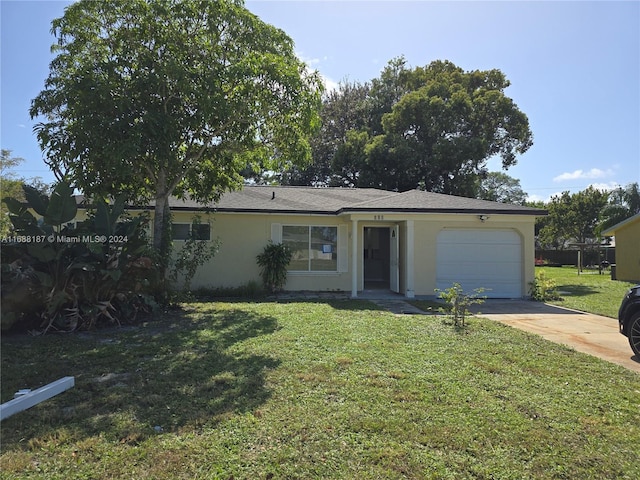 single story home featuring a garage and a front yard