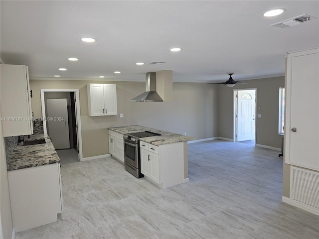 kitchen featuring white cabinetry, stone counters, wall chimney exhaust hood, and stainless steel electric stove