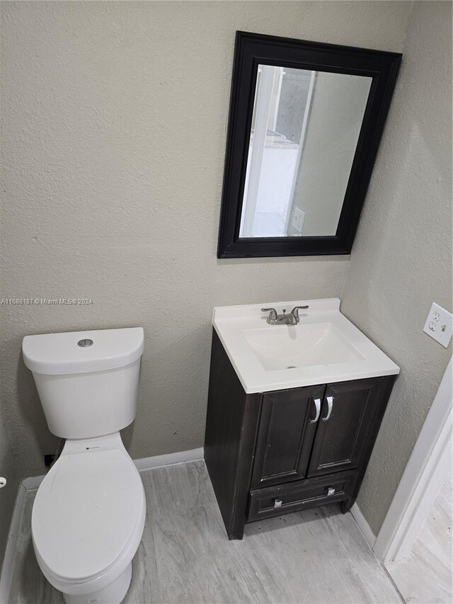 bathroom with toilet and vanity