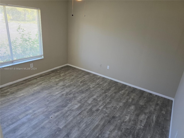 unfurnished room with dark hardwood / wood-style floors