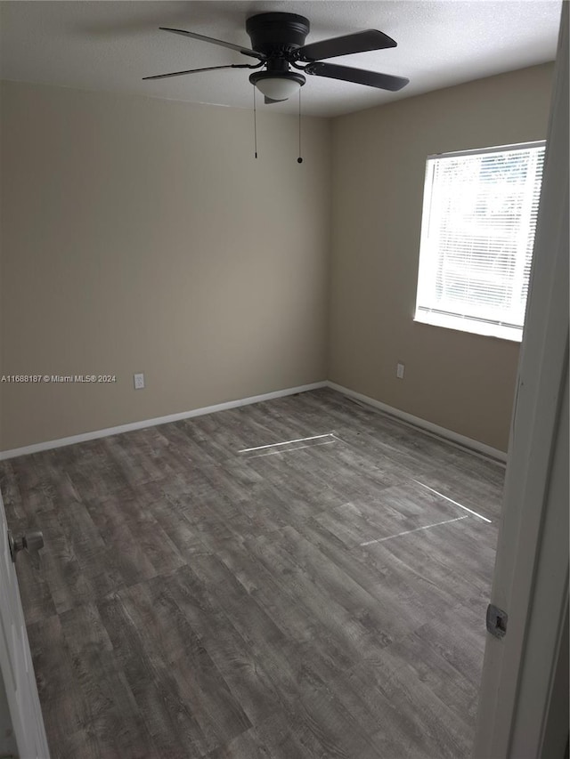 empty room featuring hardwood / wood-style floors and ceiling fan